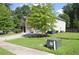 Charming two-story home boasts a well-maintained lawn, mature tree, and convenient two-car garage at 5896 Cliftondale Dr, Atlanta, GA 30349