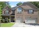 Beautiful two-story brick home with a manicured lawn and a two-car garage at 5896 Cliftondale Dr, Atlanta, GA 30349