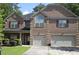 Charming two-story brick home featuring a two-car garage and manicured landscaping at 5896 Cliftondale Dr, Atlanta, GA 30349