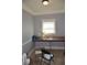 Cozy flex room with gray walls, white trim, large window and carpeted floors at 5896 Cliftondale Dr, Atlanta, GA 30349