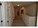 Well-lit hallway with neutral paint and carpet leads to multiple rooms at 5896 Cliftondale Dr, Atlanta, GA 30349