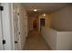 Upstairs hallway featuring neutral walls, plush carpeting, and white doors at 5896 Cliftondale Dr, Atlanta, GA 30349