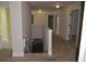 Hallway with staircase down, neutral walls, plush carpeting, and white doors at 5896 Cliftondale Dr, Atlanta, GA 30349