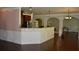 Bright kitchen featuring a granite countertop bar and dark wood cabinets at 5896 Cliftondale Dr, Atlanta, GA 30349