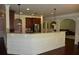 Open floor plan with arched doorways and kitchen island with granite counters at 5896 Cliftondale Dr, Atlanta, GA 30349