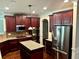 Spacious kitchen with stainless steel appliances, a granite island and cherry wood cabinetry at 5896 Cliftondale Dr, Atlanta, GA 30349