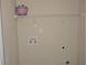 Practical laundry room with hookups and shelving, painted with neutral walls at 5896 Cliftondale Dr, Atlanta, GA 30349