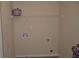 Practical laundry room with hookups and shelving, painted with neutral walls at 5896 Cliftondale Dr, Atlanta, GA 30349