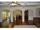 Bright, open-concept living room with hardwood floors, coffered ceiling, and easy kitchen access at 5896 Cliftondale Dr, Atlanta, GA 30349