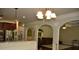 Arched entryway offers views of the living room with brown furniture at 5896 Cliftondale Dr, Atlanta, GA 30349