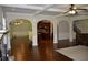 Bright, open-concept living room with hardwood floors, coffered ceiling, and easy kitchen access at 5896 Cliftondale Dr, Atlanta, GA 30349