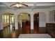 Bright, open-concept living room with hardwood floors, coffered ceiling, and easy kitchen access at 5896 Cliftondale Dr, Atlanta, GA 30349