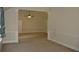 Open living room with neutral carpet and white trim at 5896 Cliftondale Dr, Atlanta, GA 30349