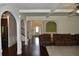 Open concept living room and foyer with arched entryways and coffered ceilings at 5896 Cliftondale Dr, Atlanta, GA 30349