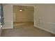 Spacious living room featuring neutral paint, carpet, and architectural column detail at 5896 Cliftondale Dr, Atlanta, GA 30349