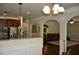 Open living spaces featuring granite countertops, arches, and dark wood flooring at 5896 Cliftondale Dr, Atlanta, GA 30349