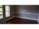Neutral-toned room featuring hardwood floors, white trim, and natural light from a window at 5896 Cliftondale Dr, Atlanta, GA 30349
