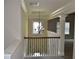 Open staircase landing with crown molding and decorative chandelier at 5896 Cliftondale Dr, Atlanta, GA 30349
