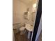 Small bathroom with a pedestal sink, toilet, and white woven accent pieces at 1297 Tree Creek Ct, Clarkston, GA 30021