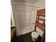 Bathroom features a white shower, toilet, and wicker shelving at 1297 Tree Creek Ct, Clarkston, GA 30021
