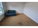Bedroom featuring carpeted floors, neutral walls, and a comfortable armchair at 1297 Tree Creek Ct, Clarkston, GA 30021