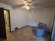 Bright bedroom with wood-look floors, ceiling fan, and a comfy chair at 1297 Tree Creek Ct, Clarkston, GA 30021