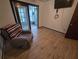 Relaxing bedroom with wood-look floors, comfy chair, and a sliding door to the sunroom at 1297 Tree Creek Ct, Clarkston, GA 30021