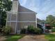 View of the siding of the two-story townhome and patio area with outdoor furniture at 1297 Tree Creek Ct, Clarkston, GA 30021
