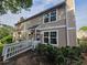 Charming two-story home with large windows, wooden walkway, and lush greenery in a well-kept neighborhood at 1297 Tree Creek Ct, Clarkston, GA 30021