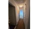 Upstairs hallway with a view of two bedrooms and three doors at 1297 Tree Creek Ct, Clarkston, GA 30021