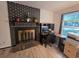 Cozy office space with a fireplace and a window, creating a bright and inviting workspace at 1297 Tree Creek Ct, Clarkston, GA 30021