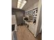 Galley kitchen featuring white appliances, cabinets, and a black brick accent wall at 1297 Tree Creek Ct, Clarkston, GA 30021