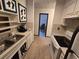 Galley kitchen featuring white appliances, cabinets, and a black brick accent wall at 1297 Tree Creek Ct, Clarkston, GA 30021