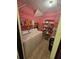 Functional laundry area with washer, dryer, shelving and pink walls at 1297 Tree Creek Ct, Clarkston, GA 30021