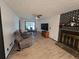 Living room with hard surface floors, fireplace and plenty of seating near the dining room at 1297 Tree Creek Ct, Clarkston, GA 30021