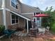 Outdoor patio area complete with a table, chairs, an umbrella and nearby foliage at 1297 Tree Creek Ct, Clarkston, GA 30021
