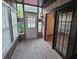 Inviting sunroom with wood paneling, multiple windows, and access to backyard at 1297 Tree Creek Ct, Clarkston, GA 30021