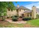Spacious backyard with stone pathway, patio with outdoor dining, landscaping and home exterior at 2864 Wyndcliff Ct, Marietta, GA 30066