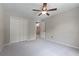 A neutral bedroom with carpet, ceiling fan, closet, and entry to hall at 2864 Wyndcliff Ct, Marietta, GA 30066