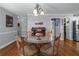 Dining room with a glass table, hardwood floors, and a view of the hallway and adjacent rooms at 2864 Wyndcliff Ct, Marietta, GA 30066