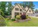 Beautiful two-story home featuring a well-manicured lawn, lush landscaping, and a two-car garage at 2864 Wyndcliff Ct, Marietta, GA 30066