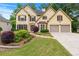 Charming two-story home featuring a well-manicured lawn and a two-car garage at 2864 Wyndcliff Ct, Marietta, GA 30066