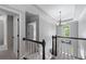 Bright hallway featuring neutral walls, a modern chandelier, and carpeted floors at 2864 Wyndcliff Ct, Marietta, GA 30066