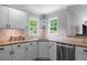 Well-lit kitchen featuring granite countertops, stainless steel appliances, and white cabinetry at 2864 Wyndcliff Ct, Marietta, GA 30066