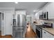 Beautiful kitchen with stainless steel appliances, granite countertops, white cabinets and tile backsplash at 2864 Wyndcliff Ct, Marietta, GA 30066