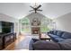 Comfortable living room featuring a stone fireplace, large windows, and a plush blue sofa at 2864 Wyndcliff Ct, Marietta, GA 30066