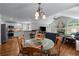Open-concept living area featuring a kitchen, dining space and living room with a stone fireplace and large arched windows at 2864 Wyndcliff Ct, Marietta, GA 30066