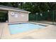 Shallow community pool with safety guidelines and basketball court nearby surrounded by trees at 2864 Wyndcliff Ct, Marietta, GA 30066