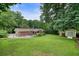 Well-maintained backyard with lush lawn, mature trees, and a storage shed at 4212 Worth Nw St, Acworth, GA 30101