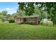 Expansive, fenced backyard with lush green grass, patio and mature trees provides a private outdoor space at 4212 Worth Nw St, Acworth, GA 30101